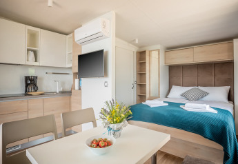 Modernes Apartment mit Küche, Esstisch, Doppelbett und stilvoller Einrichtung im Lungomare Chalet in Kroatien.