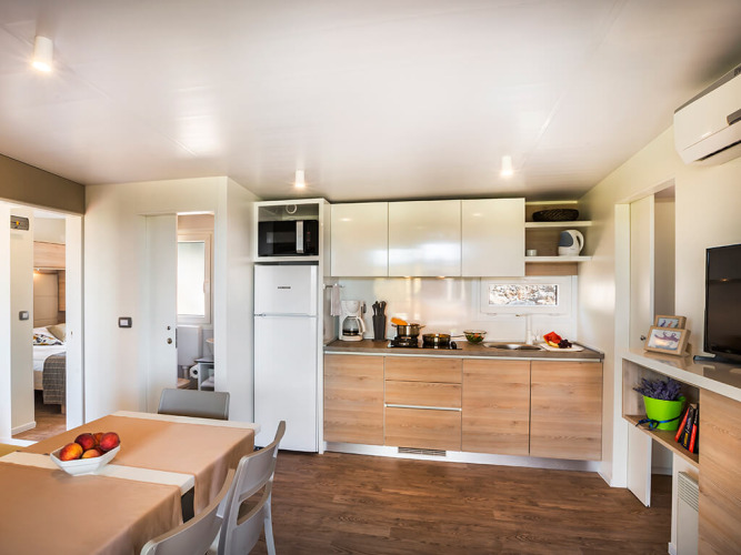 Moderne Küche und Essbereich in der Bella Vista Home Lodge mit Holzfußboden und hellem Interieur.