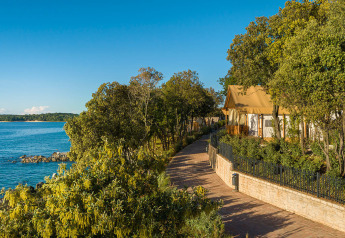 Sunset Glamping Tent Seaview al Valamar Camping Istra in Croazia con vista sul mare e vegetazione rigogliosa.