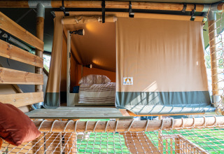 Interior view of a safari tent bedroom at Rangerlodge, Familievakantiepark Krieghuusbelten, Netherlands.
