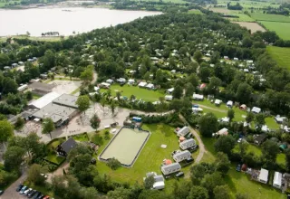 Vue aérienne du parc de vacances ’t Strandheem à Groningue, Pays-Bas, avec camping, arbres et un lac.