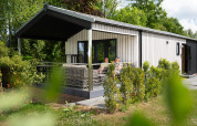 Terrace Lodge with porch, sauna, and hot tub at Holiday Resort 't Schuttenbelt in the Netherlands.