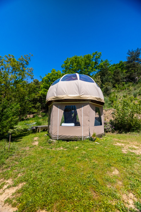 Unique bubble teepee without plumbing at Camping Des Randonneurs, France, surrounded by lush nature.