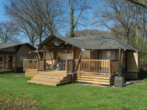 Medley Lodge safari tent with hot tub at Recreation Park Den Blanken in the Netherlands, sunny day.