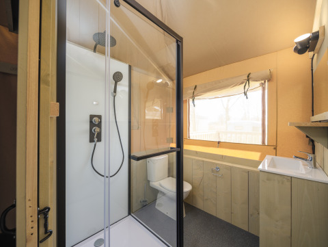 Bathroom in Medley Lodge safari tent with shower, toilet and sink at Recreation Park Den Blanken, Netherlands.