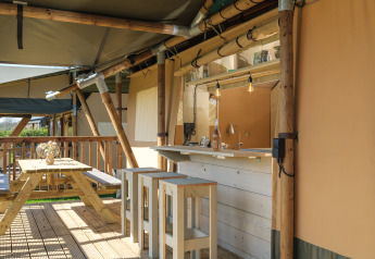 Outdoor space of the Medley Lodge safari tent with hot tub at Recreation Park Den Blanken in the Netherlands.