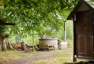 Safaritent met privé regendouche en hottub onder bomen bij Feather Down Chesters, Verenigd Koninkrijk.