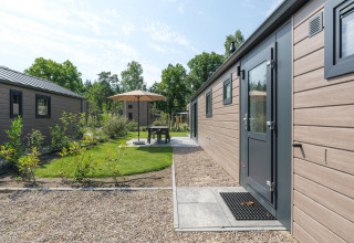 Buitenruimte bij Doornenburg Lodge in Veluwepark de Bosgraaf, Nederland, met terras en groenvoorziening.