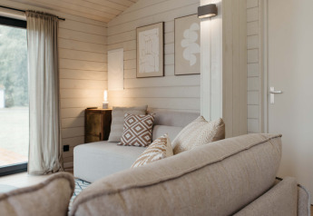 Skandinavisch eingerichtetes Wohnzimmer im Panorama Lake House Scandi mit Whirlpool in Wilsumer Berge, Deutschland.