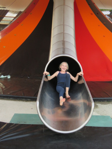 A child is enjoying a large slide at Camping Nommerlayen, a holiday park in Luxembourg, Luxembourg.