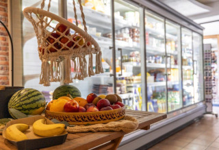 Fresh fruits including bananas, apples, and watermelon at a store in Camping Nommerlayen, Luxembourg.