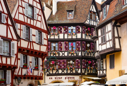 Colorful half-timbered houses and flower-adorned windows in a charming street near Herpelmont, Grand Est.