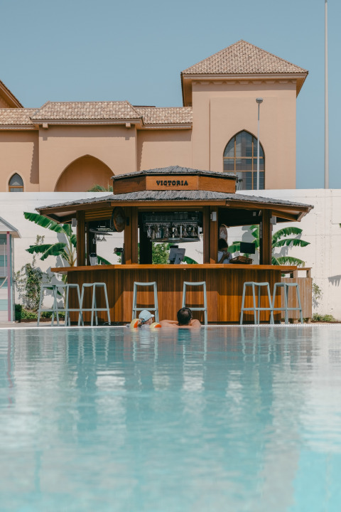 Swimming pool with the 'Victoria' pool bar at Camping Costa del Sol Glamping Village, Andalusia, Spain.
