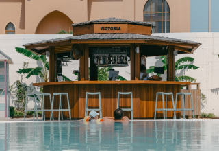 Swimming pool with the 'Victoria' pool bar at Camping Costa del Sol Glamping Village, Andalusia, Spain.