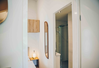 Modern interior of Tiny Lodge with bathroom and bedroom at Veluwepark de Bosgraaf, Netherlands.