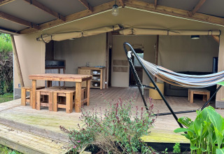 Safari telt Ecolodge cabine Cotton CONFORT ved Flower Camping Les Ilates med træmøbler og hængekøje.