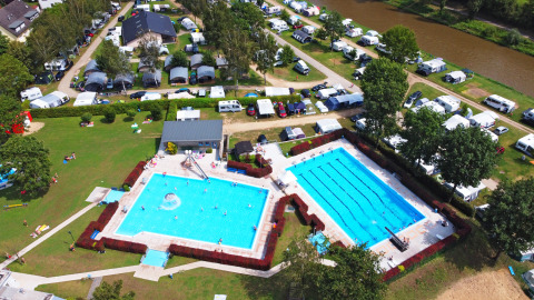 Aerial view of Campingpark Echternacherbrück featuring twin swimming pools and campsites in Rhineland-Palatinate.