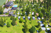Aerial view of Auf Kengert holiday park in Diekirch, Luxembourg, showing pool, campsites and green open spaces.