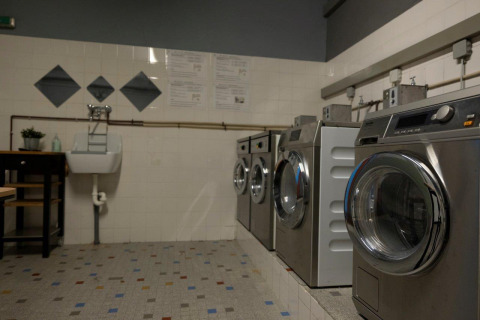 Laundry room featuring modern washing machines at Auf Kengert holiday park in Diekirch, Luxembourg.