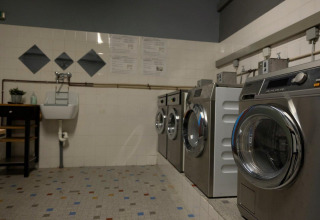 Laundry room featuring modern washing machines at Auf Kengert holiday park in Diekirch, Luxembourg.