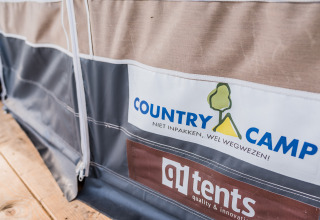 Close-up of a tent at Auf Kengert Lodge de Luxe in Luxembourg, showing Country Camp and qi tents logos.