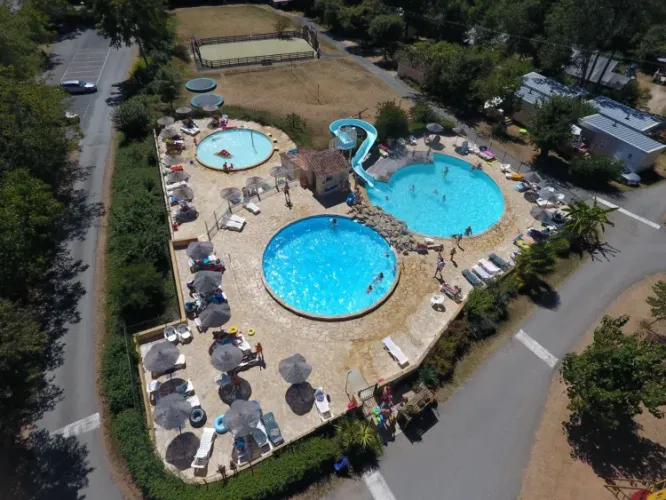 Luftaufnahme von Pools und einer Wasserrutsche im Camping Le Clou, Nouvelle-Aquitaine, Frankreich.