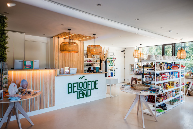 Bright and modern reception and shop area at a glamping accommodation featuring wooden accents.