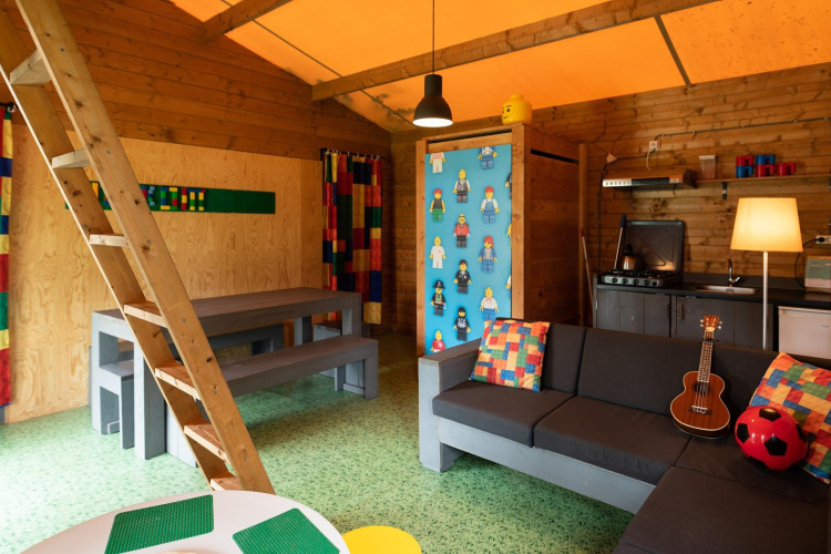 Interior of the Lego-themed safari tent at Beloofde Land in the Netherlands, featuring colorful decor.