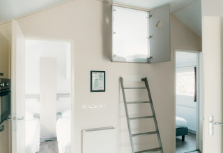 Innenaufnahme der Veluwe Lounge + Sauna Lodge im Ferienpark De Boshoek mit Leiter zu einem Hochbett.
