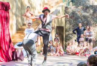 Clowns performing for an audience of children and adults outdoors at Camping Begur, Catalonia, Spain.
