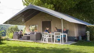 Family enjoying outdoor time at a Begur Safaritent de Luxe with terrace at Camping Begur in Spain