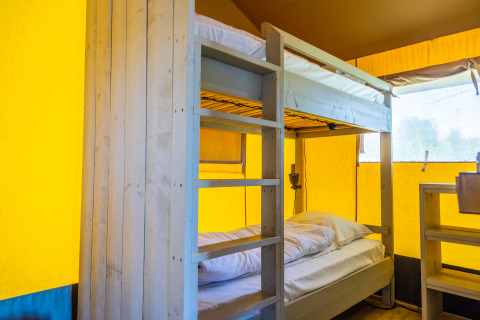 Bunk bed inside Lodgetent 4 safari tent at Zuiderzee, Netherlands, with bright yellow tent walls.