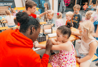 Kinderen laten zich schminken tijdens een activiteitenmiddag in Holiday park De Boshoek in Gelderland.