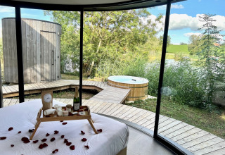 Panoramabillede af Lumipod Spa île-hytten på Domaine des Feuilles i Frankrig, med udsigt til spa og natur.
