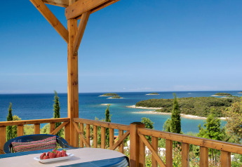 View from Orsera Home at Camping Orsera, Croatia, showing terrace, sea, and small islands in the distance.