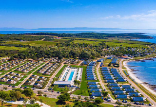 Aerial view of Camping Arena Grand Kažela’s holiday park with mobile homes, pool, and seaside in Istria, Croatia.