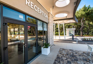 Reception area at Camping Arena Grand Kažela holiday park in Istria, Croatia, featuring modern architecture.