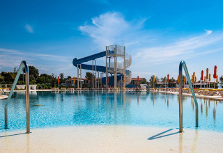 Holiday park in Istria, Croatia, showing a large pool, sun loungers, and a blue waterslide at Camping Arena Grand Kažela.