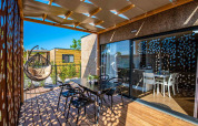Modern outdoor terrace at Camping Home Green, Camping Arena Grand Kažela, Croatia, with stylish seating.