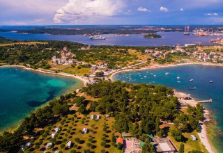 Aerial view of Camping Arena Stoja holiday park in Istria, Croatia, featuring coastline and campers.