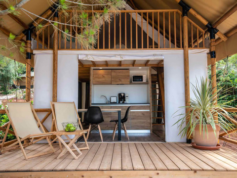 Two bedroom glamping safari tent with loft, wooden deck, and seating at Camping Arena Stoja in Croatia.