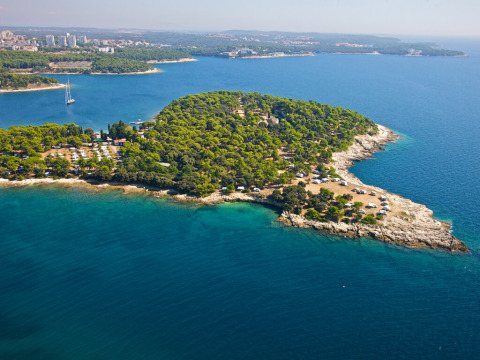 Vista aerea del Camping Arena Stoja in Istria, Croazia, circondato da alberi verdi e dal mare turchese.
