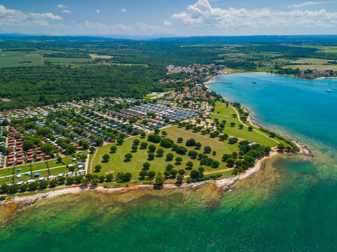 Aerial view of Camping Park Umag in Istria, Croatia, showing coastline, green park areas and campsites.