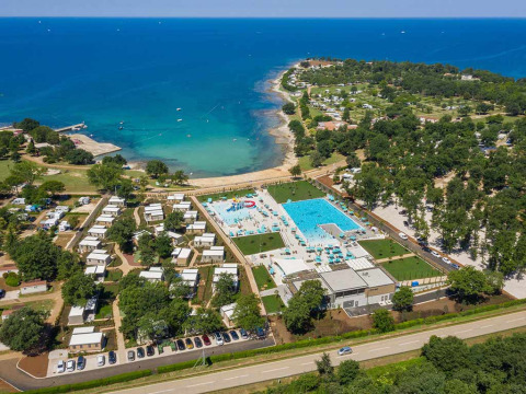 Aerial view of Camping Park Umag in Istria, Croatia, featuring pools, cabins, and coastal scenery