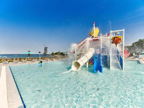 Parco acquatico con scivoli e secchio d'acqua al Camping Park Umag, vista mare in Istria, Croazia.