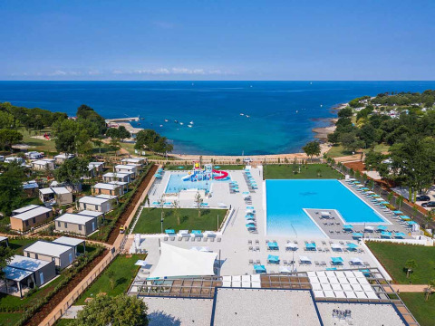 Aerial view of Camping Park Umag in Istria, Croatia, showing pools, cabins, and the Adriatic Sea.