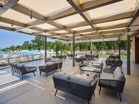 Outdoor lounge area at Camping Park Umag, Istria, Croatia, featuring modern sofas and a view of the pool.
