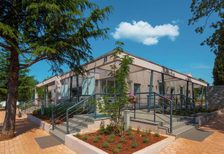 Modern building with steps and glass windows at Camping Park Umag, Istria, Croatia on a sunny day.