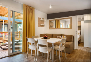 Modern dining and living area at Lopar Garden Home, Valamar Camping San Marino, Croatia, with terrace access.
