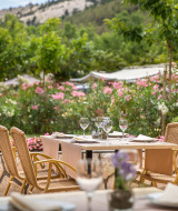 An outdoor dining area at Valamar Camping San Marino in Croatia, surrounded by flowers and nature.
